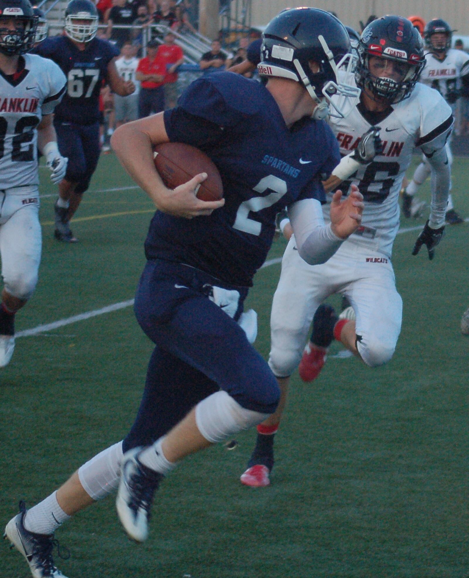 Valley View quarterback Collin Wood takes a peak at Franklin defender Xack Arnwine as he heads to the end zone in the first quarter Friday night at Barker Field in Germantown. CONTRIBUTED PHOTO BY JOHN CUMMINGS