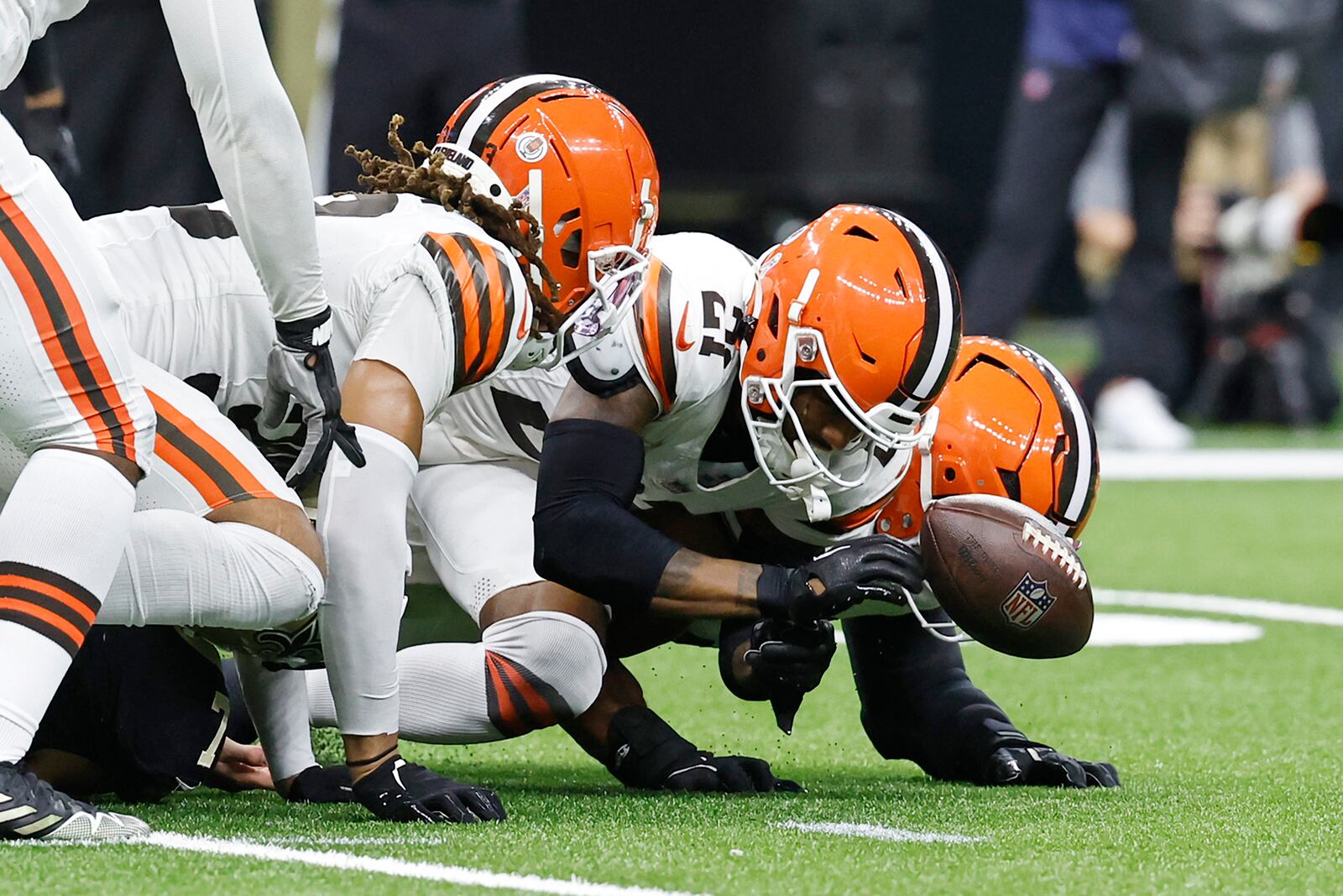 Cleveland Browns cornerback Denzel Ward, center, recovers a fumble by New Orleans Saints tight end Taysom Hill in the first half of an NFL football game in New Orleans, Sunday, Nov. 17, 2024. (AP Photo/Butch Dill)