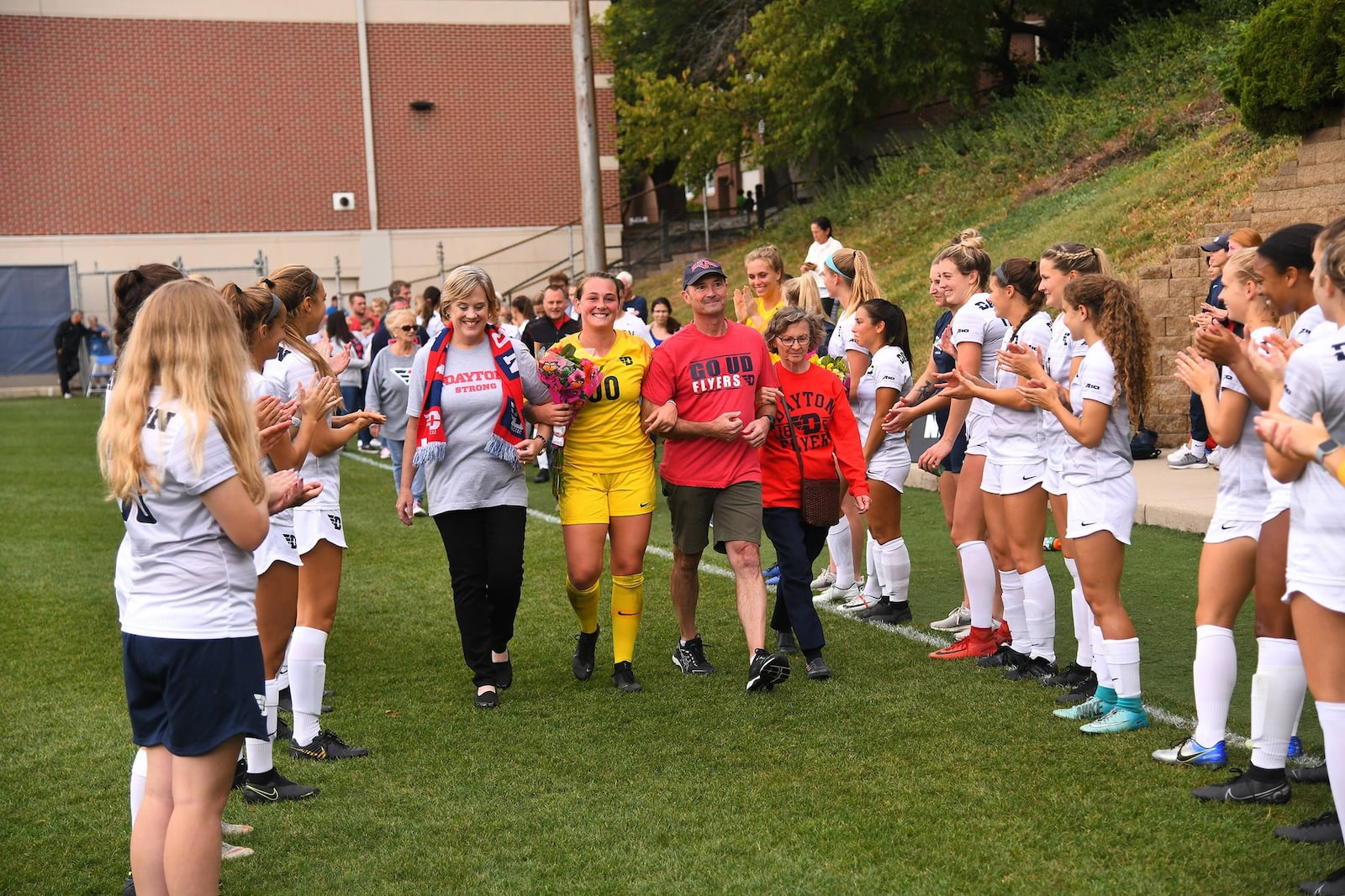 University of Dayton women’s soccer player Emily Jones escorted onto Baujan Field on Senior Day by her parents Karen and Randy. CONTRIBUTED