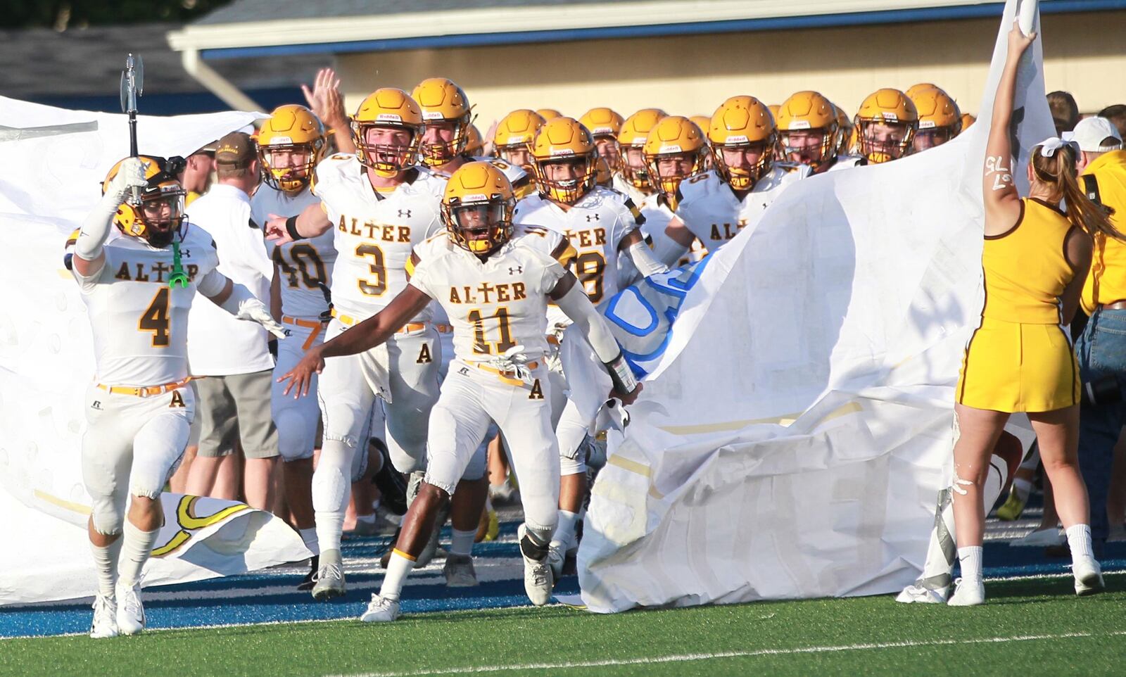 Jack McKelvey (left, 4), Kale Steneman (3) and Marcael O’Neal (11) lead Alter onto the field. Alter defeated host Fairmont 21-7 in a Week 1 high school football game on Thursday, Aug. 29, 2019. MARC PENDLETON / STAFF