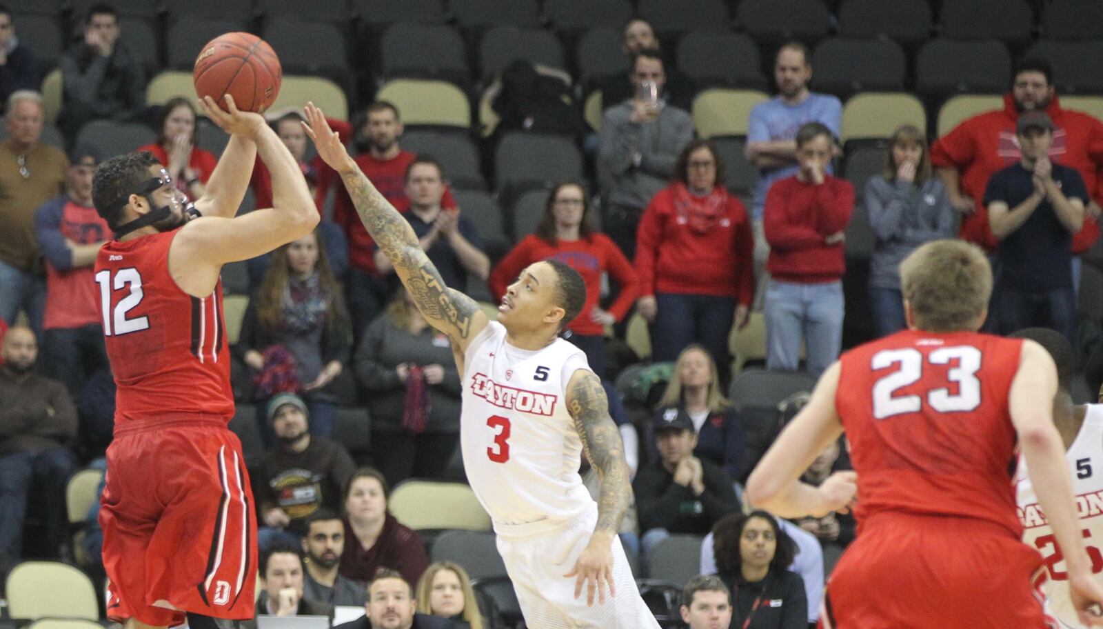 Davidson’s Jack Gibbs makes a go-ahead 3-pointer against Dayton’s Kyle Davis with 51 seconds left in the game in the quarterfinals of the Atlantic 10 tournament on Friday, March 10, 2017, at PPG Paints Arena in Pittsburgh. David Jablonski/Staff