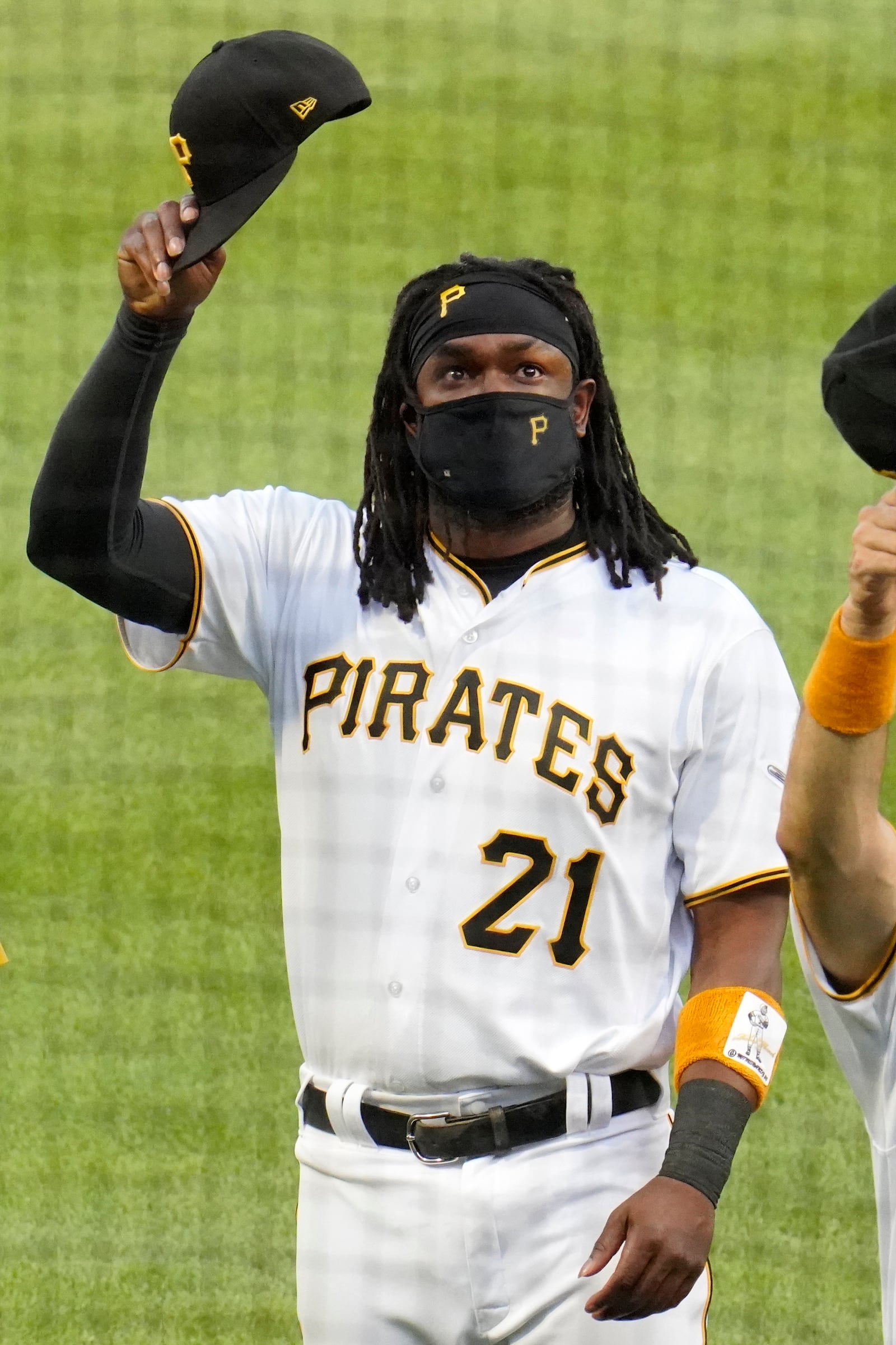 Pittsburgh Pirates' Josh Bell waves to the Clemente family following a ceremony for Roberto Clemente Day before the team's baseball game against the Chicago White Sox in Pittsburgh, Wednesday, Sept. 9, 2020. All Pirates players wore Clemente's No. 21 for the game. (AP Photo/Gene J. Puskar)