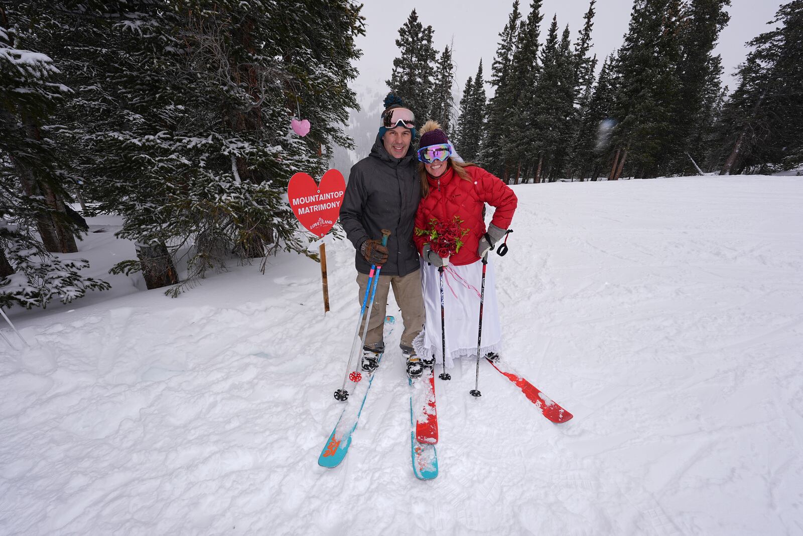 Sander and Kelley Wyjad of Longmont, Colo., arrive to renew their wedding vows during the 35th annual Marry Me & Ski for Free Valentine's Day mountaintop matrimony ceremony Friday, Feb. 14, 2025, near Georgetown, Colo. (AP Photo/David Zalubowski)