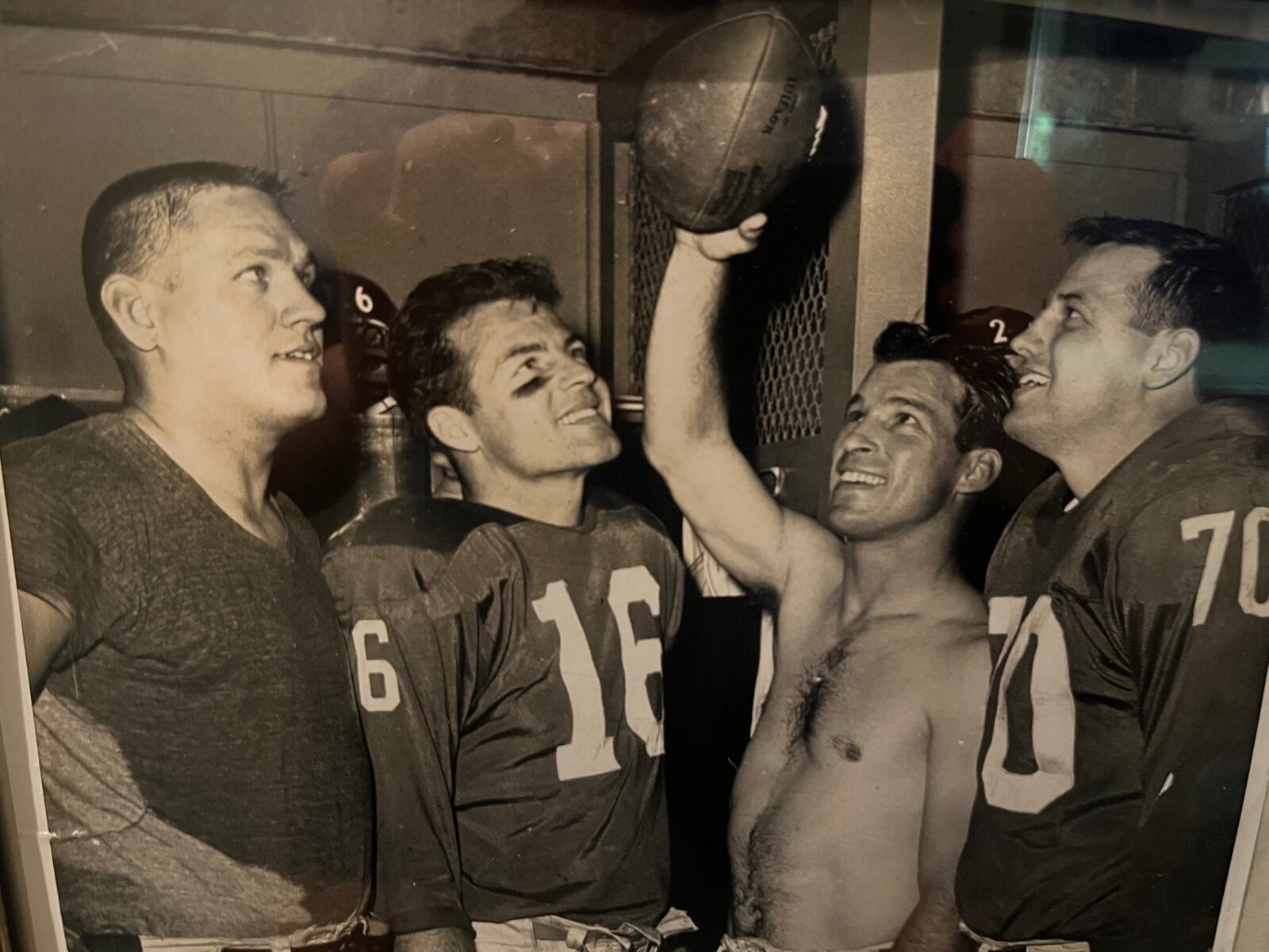 Jim Katcavage (left) celebrates in the dressing room with quarterback Frank Gifford (second from left), linebacker Sam Huff (right) and another teammate. CONTRIBUTED