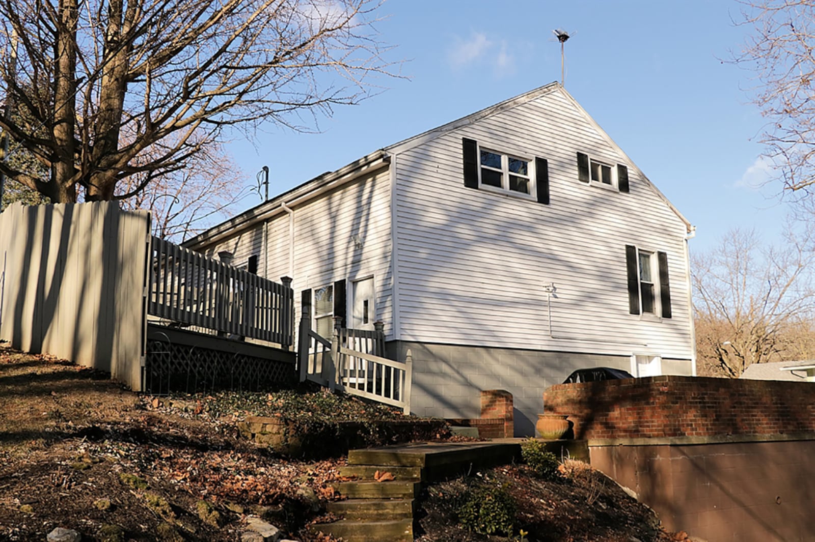 The 1.77-acre property has woods and a natural spring as well as a fenced back yard, two wooden decks, a terrace garden with stepping stones and a brick patio surrounded by a brick privacy wall. CONTRIBUTED PHOTO BY KATHY TYLER