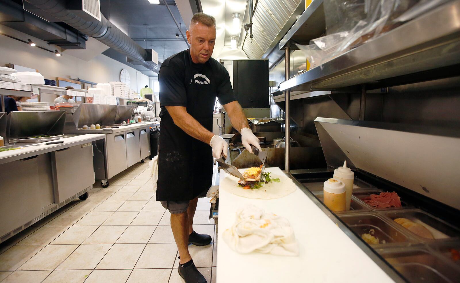 One Bistro chef Greg Shaffer works the lunch shift in Xenia.  Shaffer is in long-term recovery from drug and alcohol addiction.   TY GREENLEES / STAFF