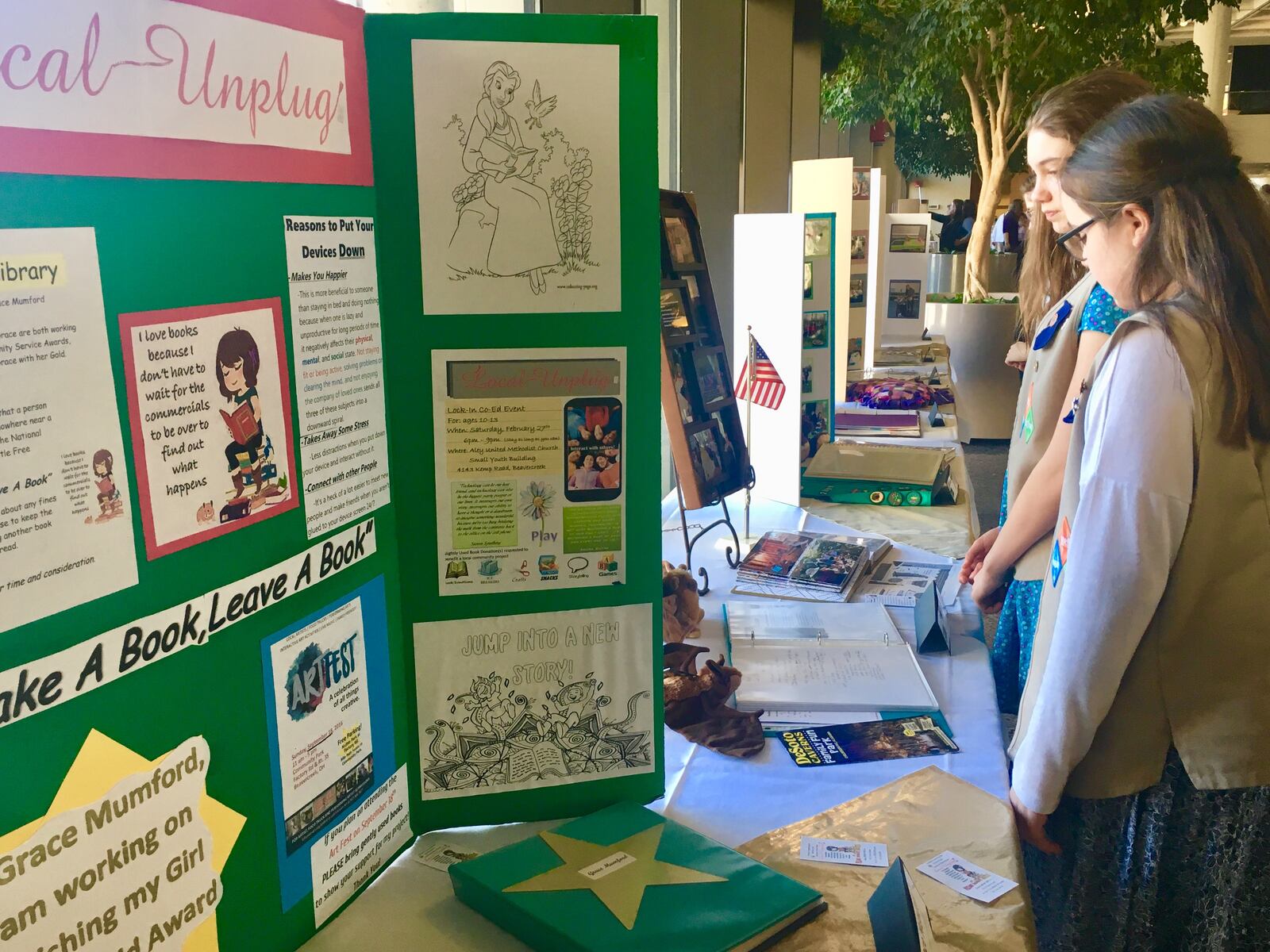 Local Girl Scouts look over the projects that won Gold Awards this year, the top honor for high school Girl Scouts. 21 Dayton-area Girl Scouts received the award this year and were honored at a ceremony at Sinclair Community College Sunday, March 4, 2018.