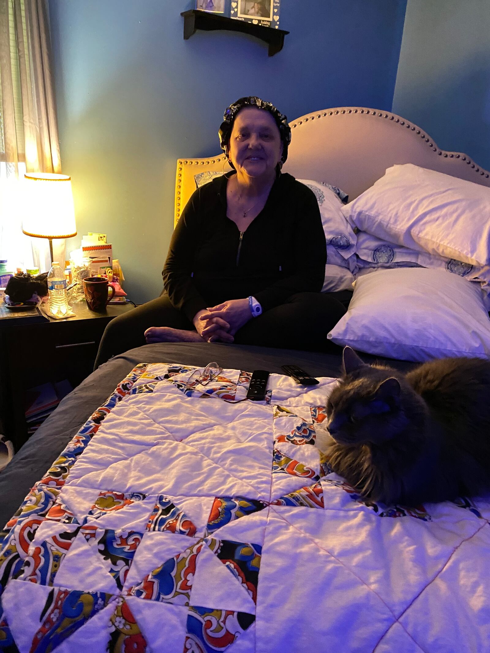 Marilyn Watson with her cat, Smokey, in her bedroom. Watson lives in Madden Hills and says she has worked several times with Rebuilding Together Dayton to get needed repairs on her home. EILEEN McCLORY STAFF