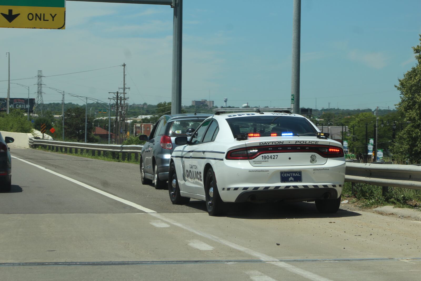 Dayton police officers pull over a car on U.S. 35 in downtown Dayton. CORNELIUS FROLIK / STAFF