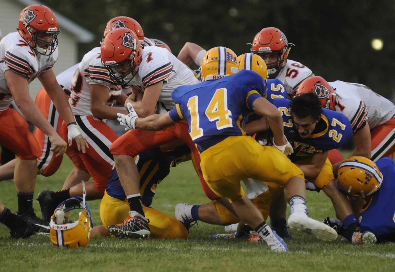 Coldwater QB Dylan Thobe (7) is met by Marion Local defenders Duane Leugers (14) and Ryan Thobe (27), who loses his helmet. Coldwater defeated host Marion Local 17-14 in a Week 3 Midwest Athletic Conference high school football showdown at Maria Stein on Friday, Sept. 9, 2016. MARC PENDLETON / STAFF