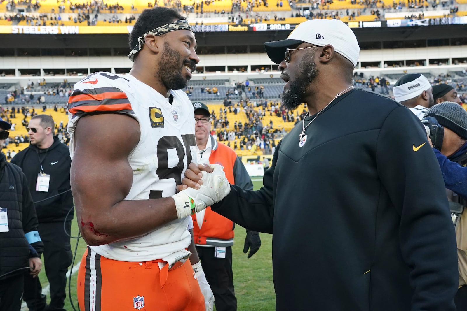 Cleveland Browns defensive end Myles Garrett (95) and Pittsburgh Steelers head coach Mike Tomlin, right, meet after an NFL football game in Pittsburgh, Sunday, Dec. 8, 2024 (AP Photo/Matt Freed)