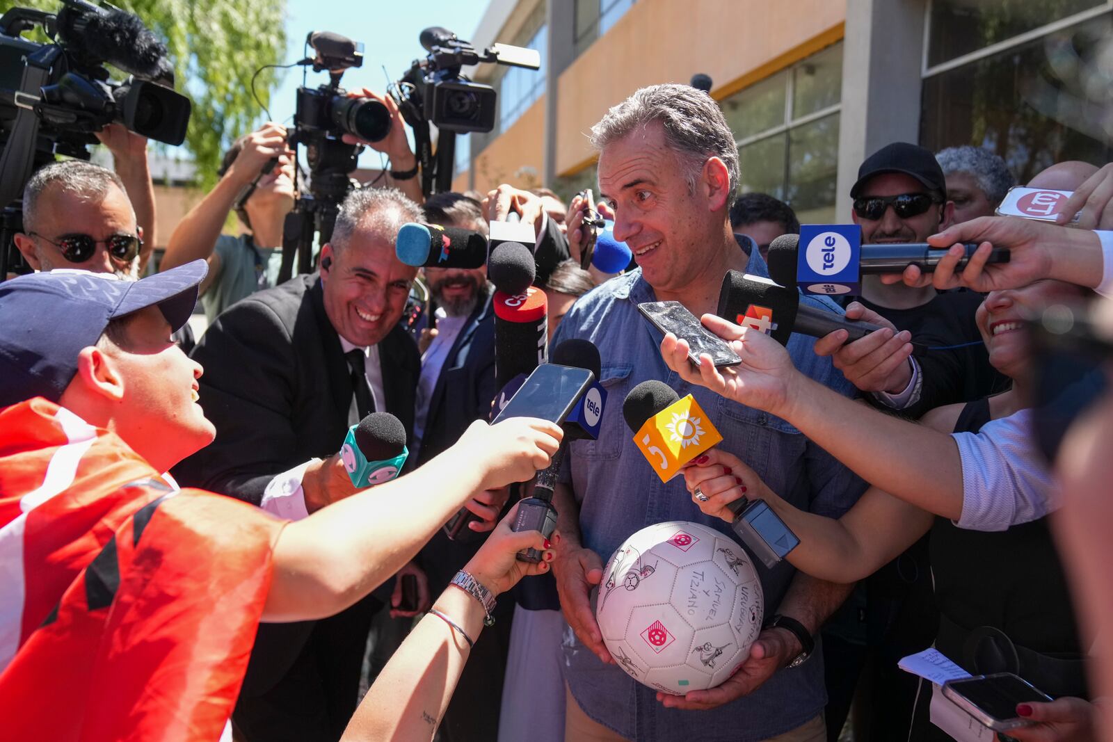 Yamandu Orsi, presidential candidate from the Broad Front, or Frente Amplio, talks to journalists after voting in the presidential run-off election in Canelones, Uruguay, Sunday, Nov. 24, 2024. (AP Photo/Matilde Campodonico)