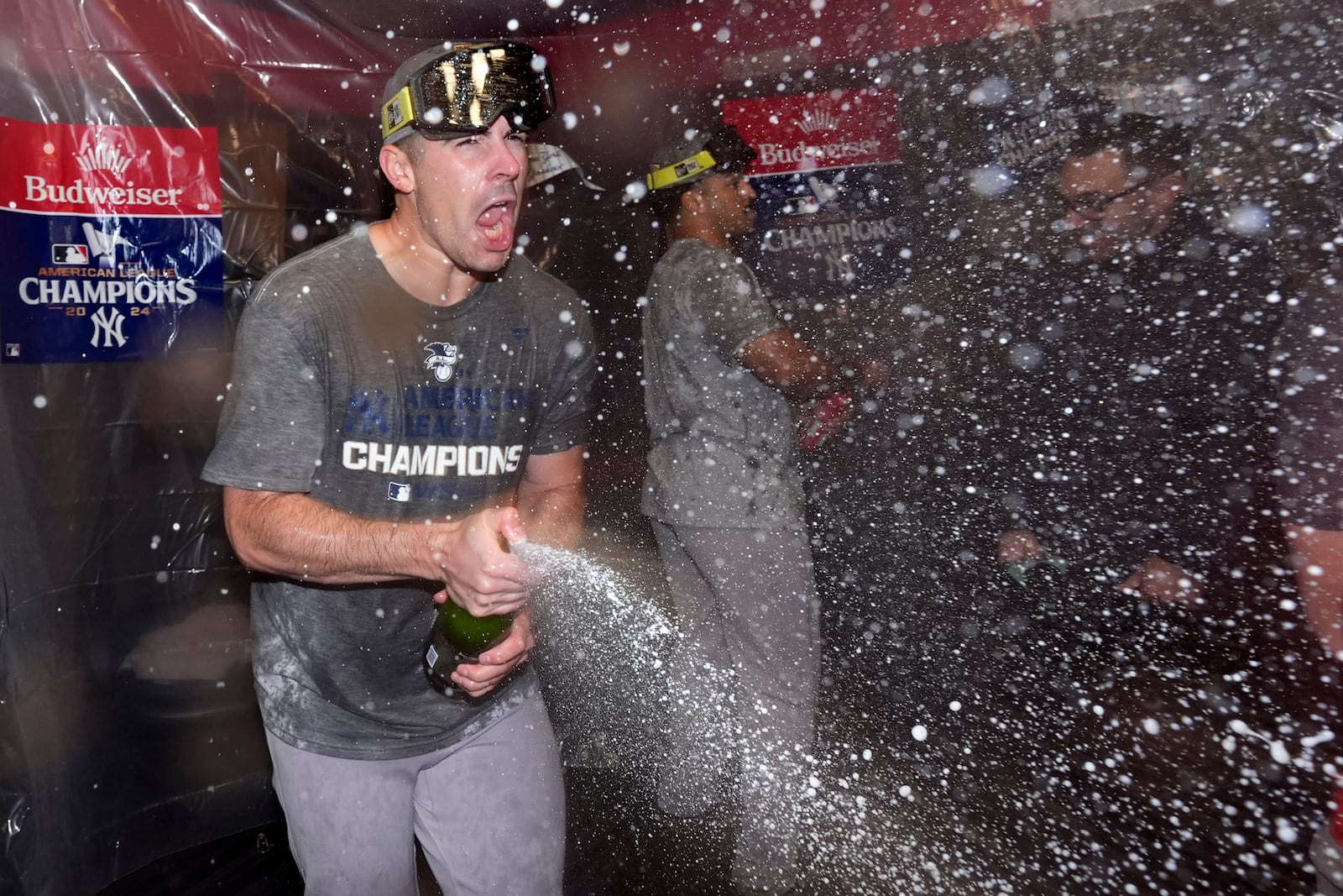 New York Yankees' Carlos Rodón celebrates in the clubhouse after Game 5 of the baseball AL Championship Series against the Cleveland Guardians Sunday, Oct. 20, 2024, in Cleveland. The Yankees won 5-2 to advance to the World Series. (AP Photo/Godofredo A. Vásquez )