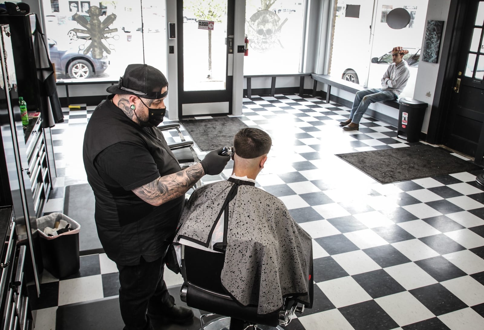 Fairborn barber, Dane Welch cuts Zach Cornett's hair. Cornett is from Yellow Springs. JIM NOELKER/STAFF