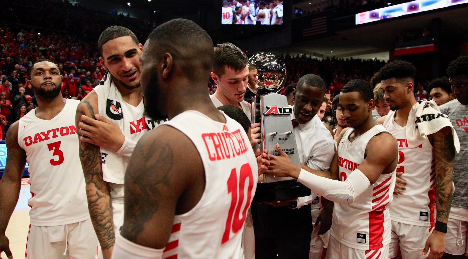 Dayton celebrates with the A-10 championship trophy on Saturday, March 7, 2020, at UD Arena.