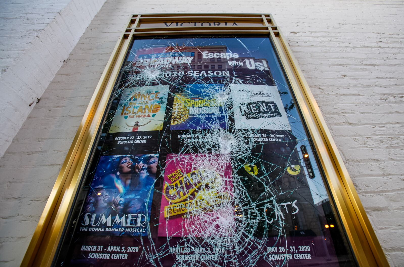 Victoria Theatre on Main Street had multiple windows and display board glass smashed in downtown Dayton Sunday morning, May 31, after protests throughout the day on Saturday in the aftermath of the death of George Floyd. CIty and county workers, business owners and volunteers spent the morning sweeping up glass and scrubbing spray paint. NICK GRAHAM / STAFF