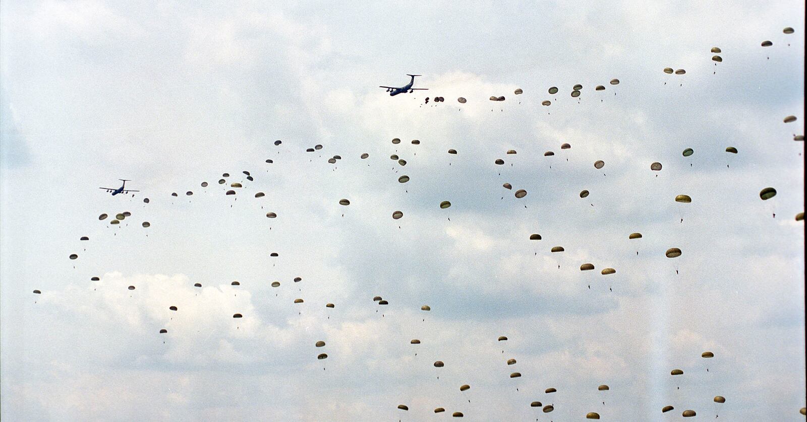 A sky full of 82nd Airborne soldiers dropped from C-141 Starlifters.