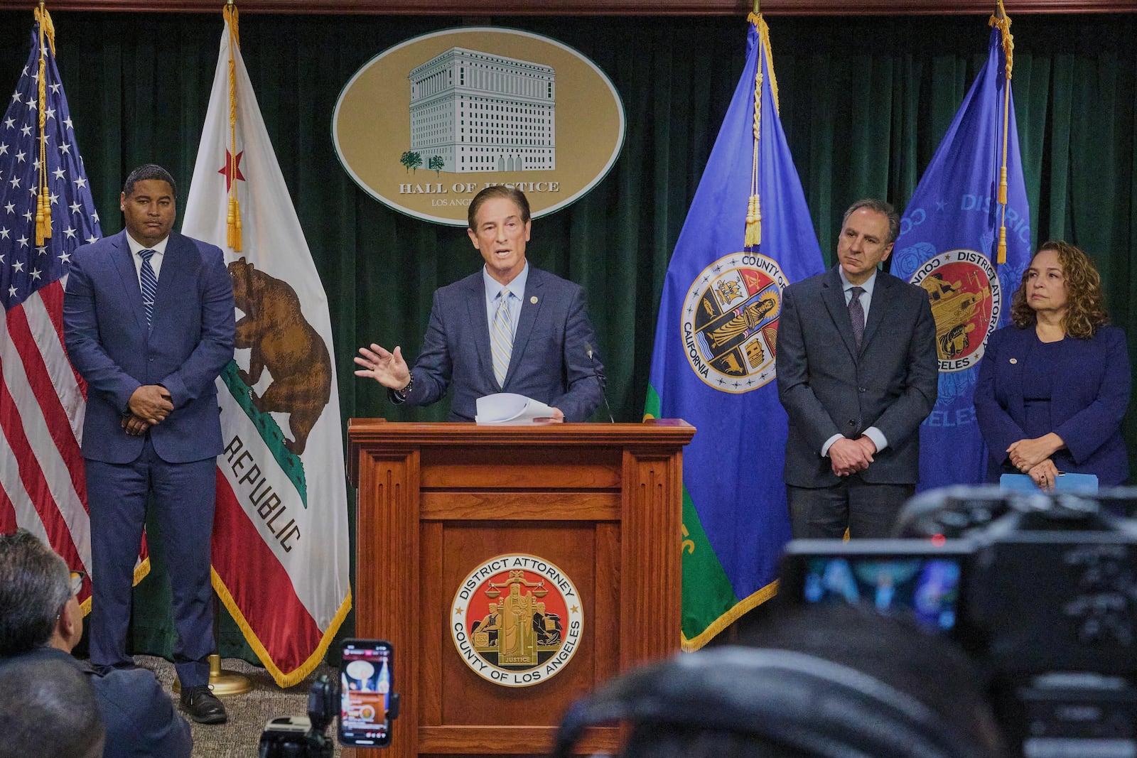 Los Angeles County District Attorney Nathan Hochman is surrounded by law enforcement officials as he gives a news conference about the Menendez brothers case in Los Angeles, Monday, March 10, 2025. (AP Photo/Damian Dovarganes)