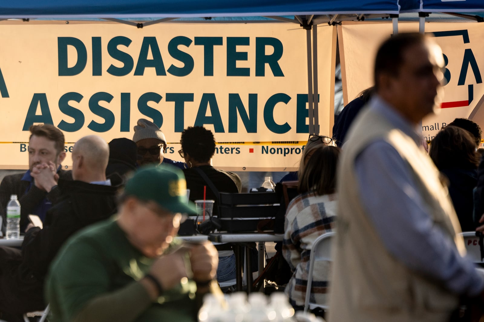 People impacted by the wildfires seek information and relief at a FEMA Disaster Recovery Center at Pasadena City College Thursday, Jan. 16, 2025, in Pasadena, Calif. (AP Photo/Etienne Laurent)