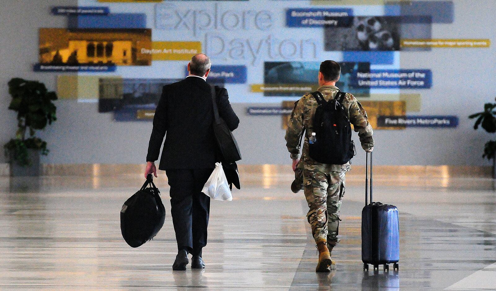 Travelers walk through Dayton International Airport Thursday, June 27, 2024. The airport will be busy for Independence Day week as travel nationwide is expected to be 5% greater than in 2023 and 8% greater than 2019. MARSHALL GORBY/STAFF