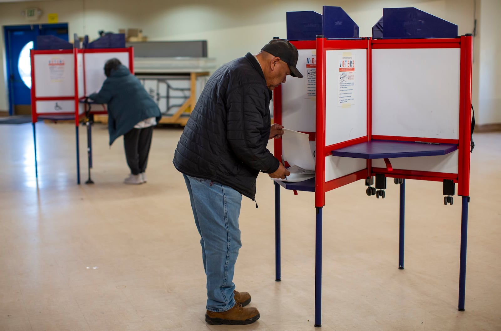 Voters mark their ballots at a polling station on the Navajo Nation in Fort Defiance, Ariz., on Election Day, Tuesday, Nov. 5, 2024. (AP Photo/Andres Leighton)