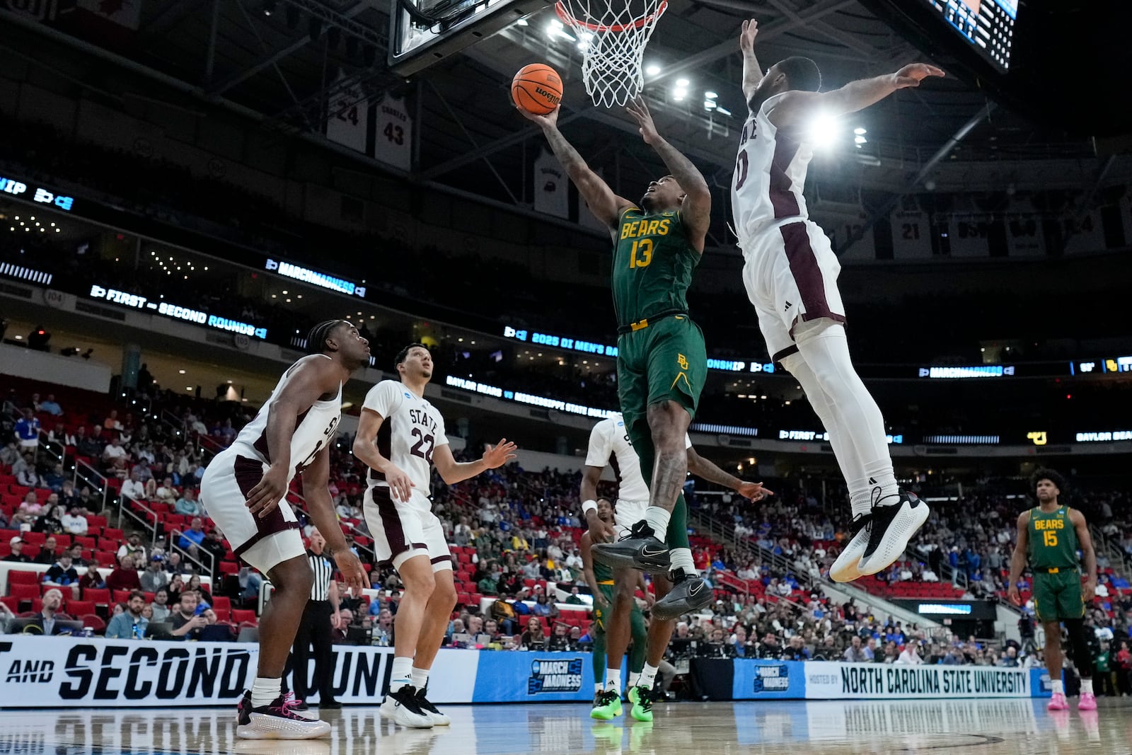 Baylor guard Langston Love drives to the basket past Mississippi State guard Claudell Harris Jr. during the first half in the first round of the NCAA college basketball tournament, Friday, March 21, 2025, in Raleigh, N.C. (AP Photo/Chris Carlson)