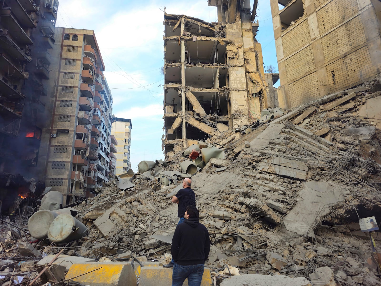 Residents check the site of an Israeli airstrike in Dahiyeh, Beirut, Lebanon, Saturday, Nov. 9, 2024. (AP Photo/Hassan Ammar)