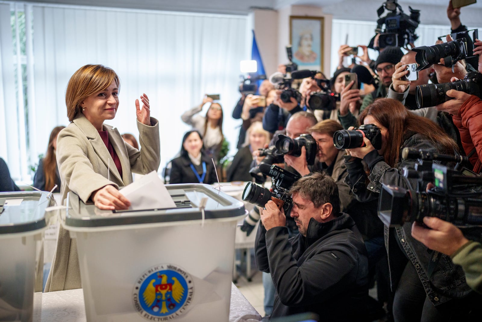 Moldova's President Maia Sandu prepares to cast her vote, in Chisinau, Moldova, Sunday, Oct. 20, 2024, during a presidential election and a referendum on whether to enshrine in the Constitution the country's path to European Union membership. (AP Photo/Vadim Ghirda)