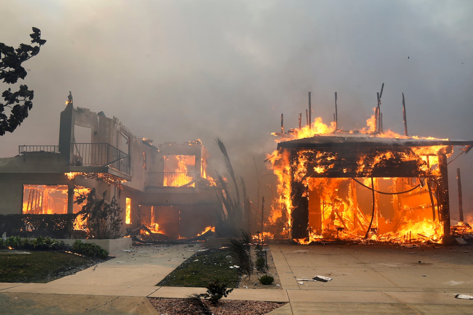 The Palisades Fire ravages a neighborhood amid high winds in the Pacific Palisades neighborhood of Los Angeles, Wednesday, Jan. 8, 2025. (AP Photo/Damian Dovarganes)