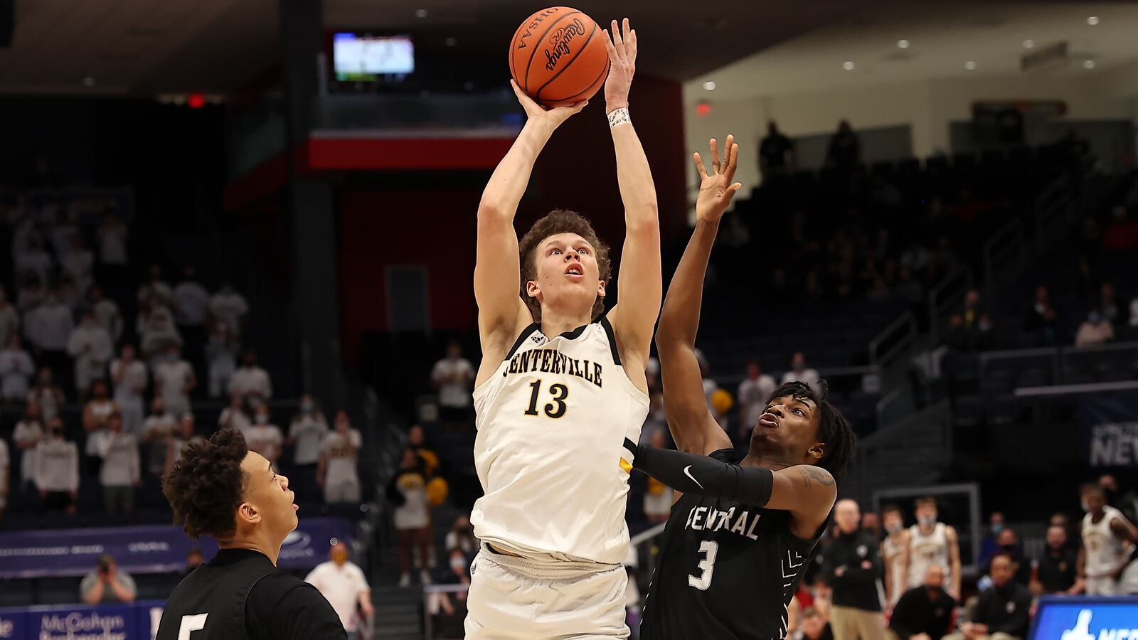 Centerville's Rich Rolf puts up a shot against Westerville Central's MJ Davis (3) in the Division I boys basketball state championship game on Sunday night at UD Arena. Michael Cooper/CONTRIBUTED