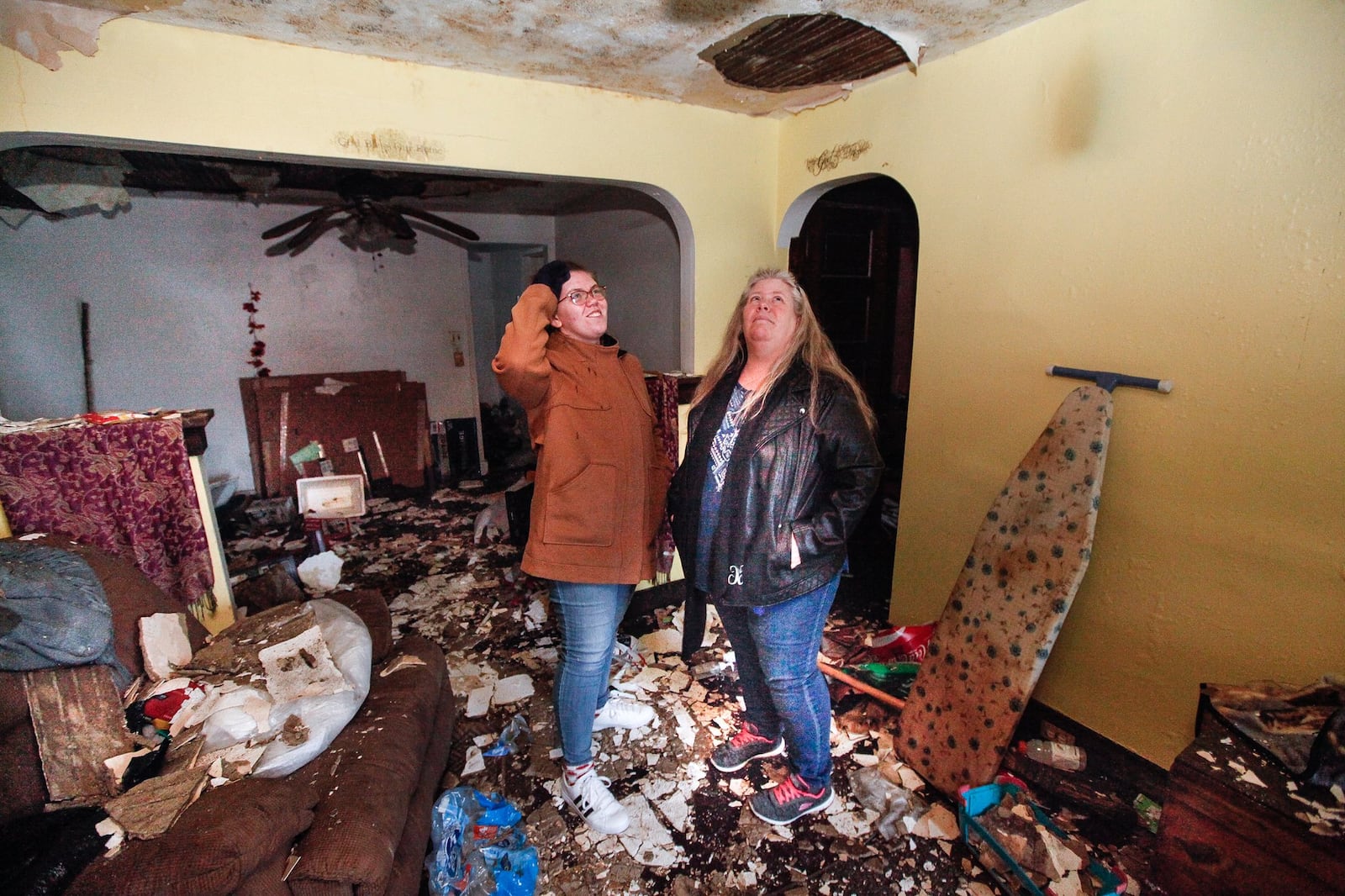 Water drips on tornado survivors, Christine Creager, right, and her daughter Kansas, as they visit their Macready Avenue home in Old North Dayton. Their house will be among the first to be rebuilt this spring by volunteer groups organized through the Miami Valley Long-Term Recovery Operations Groupâ€™s case management system. CHRIS STEWART / STAFF