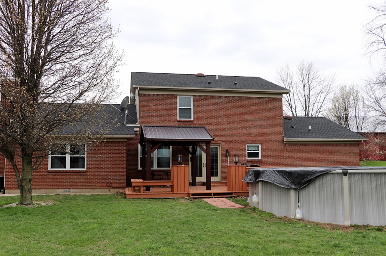 French patio doors, installed in 2018, open off the dining room to a wooden deck, which is partly covered by a pergola. The above-ground swimming pool is near the deck but not connected. CONTRIBUTED PHOTO BY KATHY TYLER