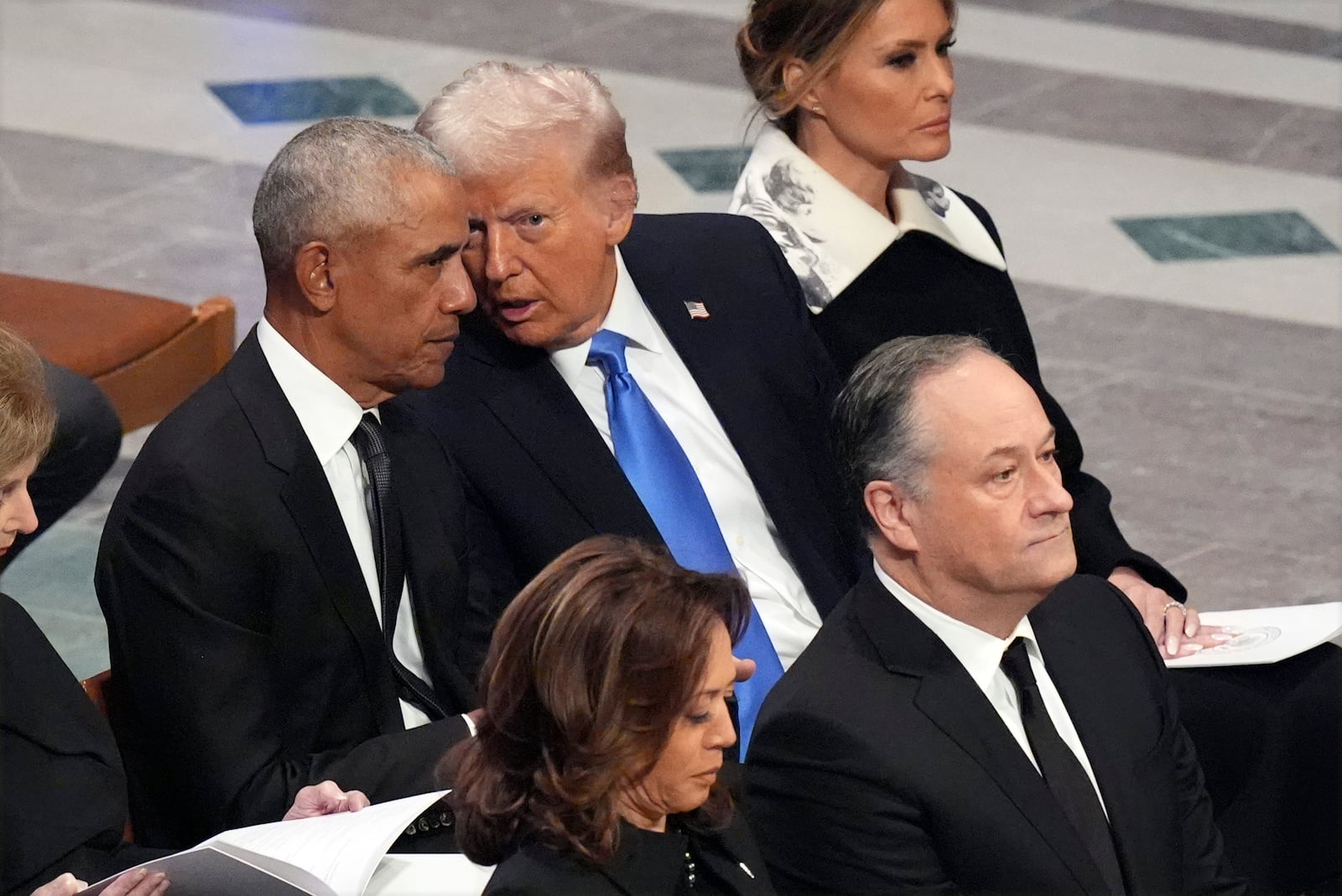 Former President Barack Obama talks with President-elect Donald Trump as Melania Trump listens and as Vice President Kamala Harris and second gentleman Doug Emhoff arrive, before the state funeral for former President Jimmy Carter at Washington National Cathedral in Washington, Thursday, Jan. 9, 2025. (AP Photo/Jacquelyn Martin)