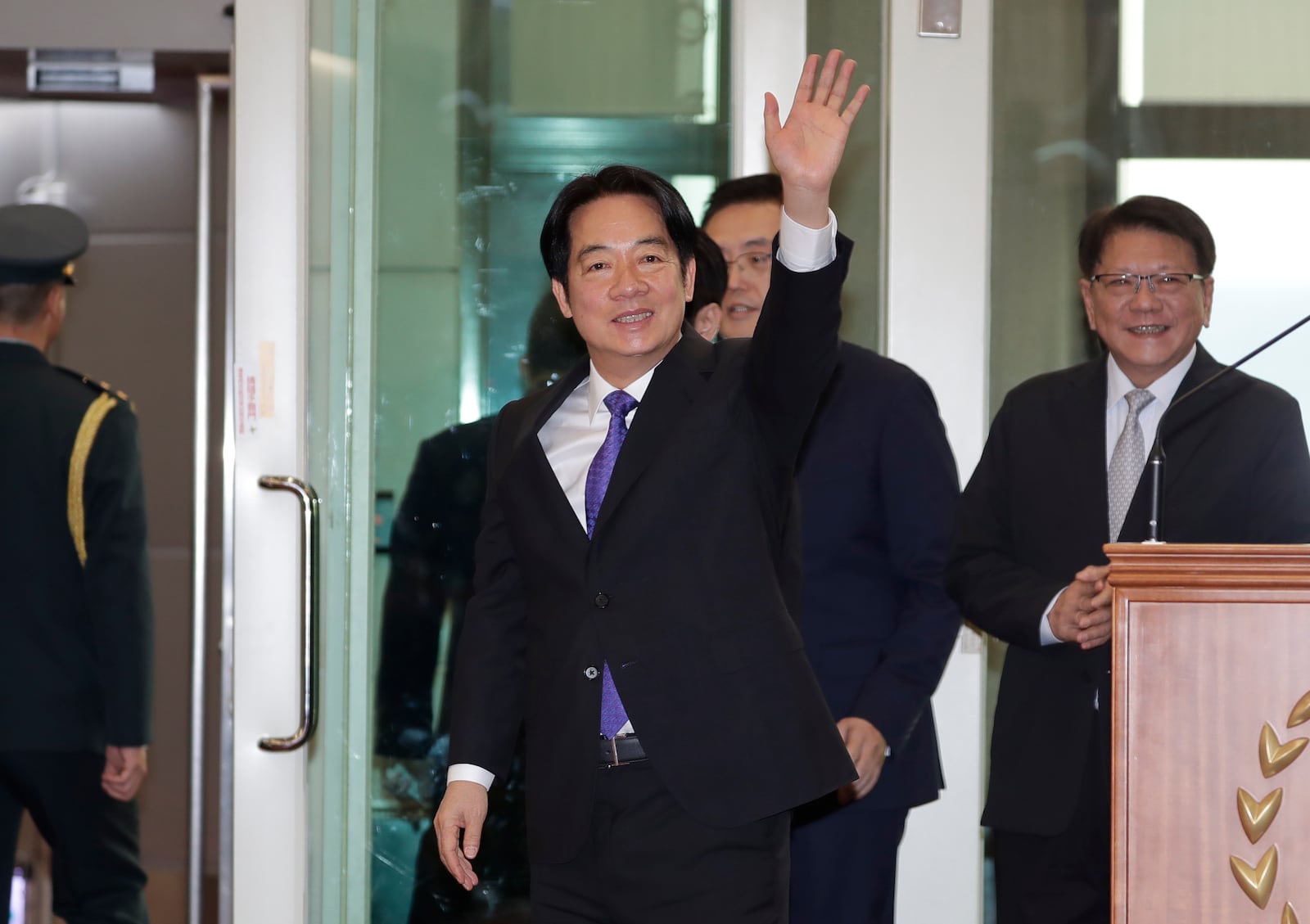 Taiwanese President Lai Ching-te waves to the media as he departs for South Pacific at Taoyuan International Airport in Taoyuan, Taiwan, Saturday, Nov. 30, 2024. Lai leave Taiwan on Saturday on a weeklong trip to visit the Marshall Islands, Tuvalu and Palau 'X three diplomatic allies of the self-governed island. (AP Photo/Chiang Ying-ying)