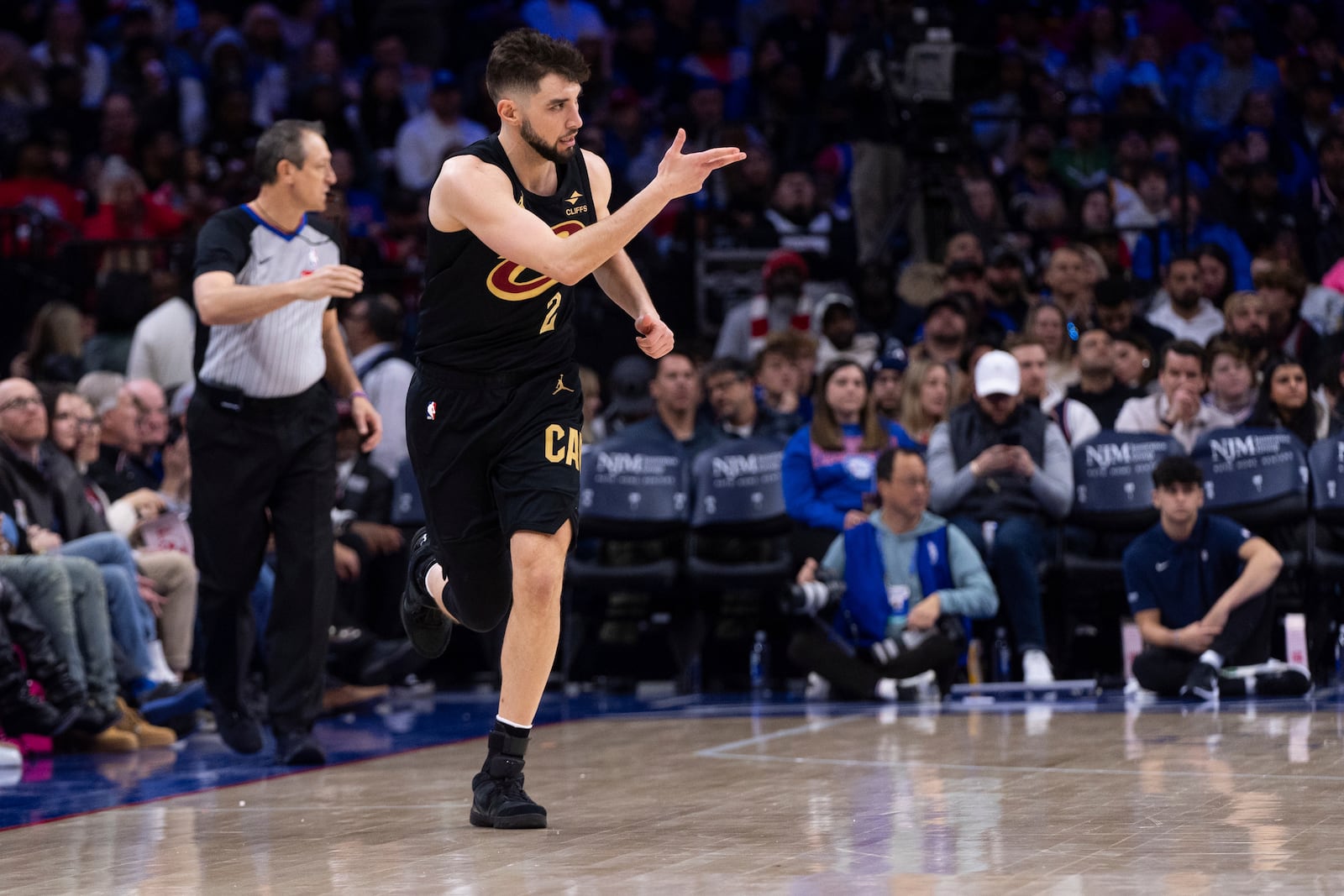 Cleveland Cavaliers' Ty Jerome (2) reacts after his 3-point basket during the first half of an NBA basketball game against the Philadelphia 76ers, Friday, Jan. 24, 2025, in Philadelphia. (AP Photo/Chris Szagola)