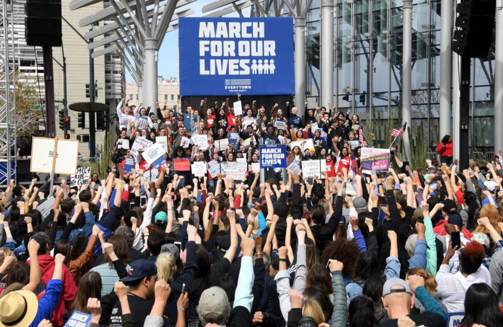 People raise their fists as organizer Denise Hooks speaks during the March for Our Lives rally at Las Vegas City Hall on Saturday.