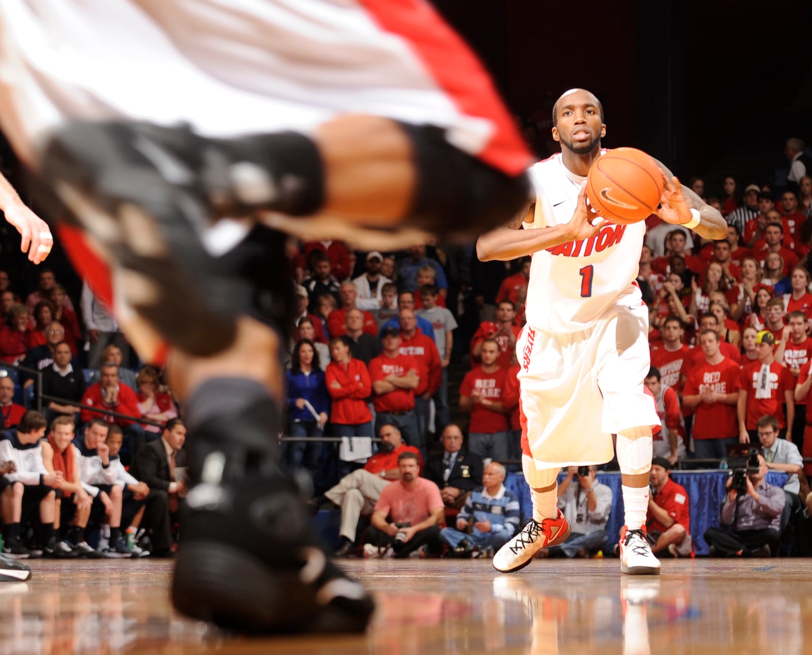 Dayton’s Kevin Dillard makes a pass against Butler in 2013 at UD Arena. Photo by Erik Schelkun