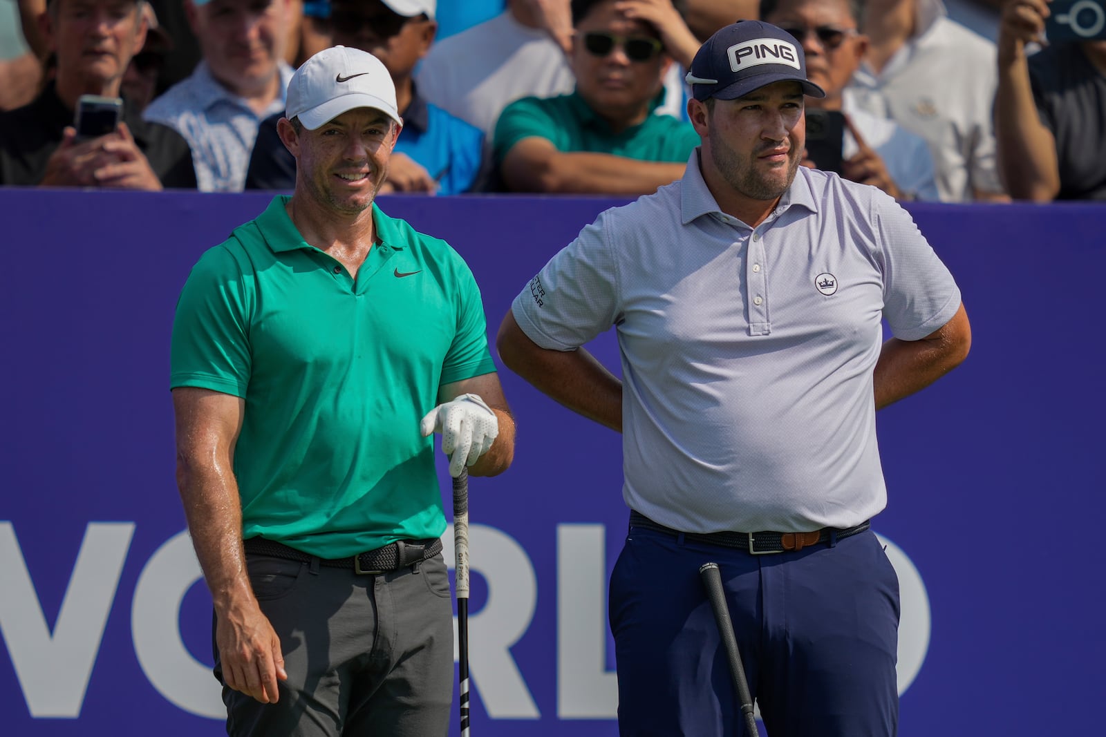 Rory McIlroy of Northern Ireland, left, and Thriston Lawrence of South Africa wait before the first tee off during the first round of World Tour Golf Championship in Dubai, United Arab Emirates, Thursday, Nov. 14, 2024. (AP Photo/Altaf Qadri)