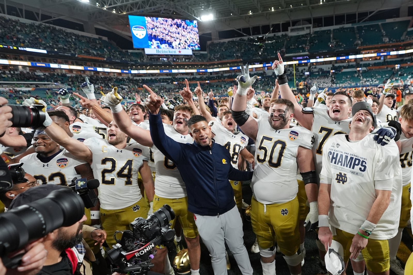 Notre Dame head coach Marcus Freeman an the team sing to fans after winning the Orange Bowl College Football Playoff semifinal game against Penn State, Thursday, Jan. 9, 2025, in Miami Gardens, Fla. (AP Photo/Rebecca Blackwell)