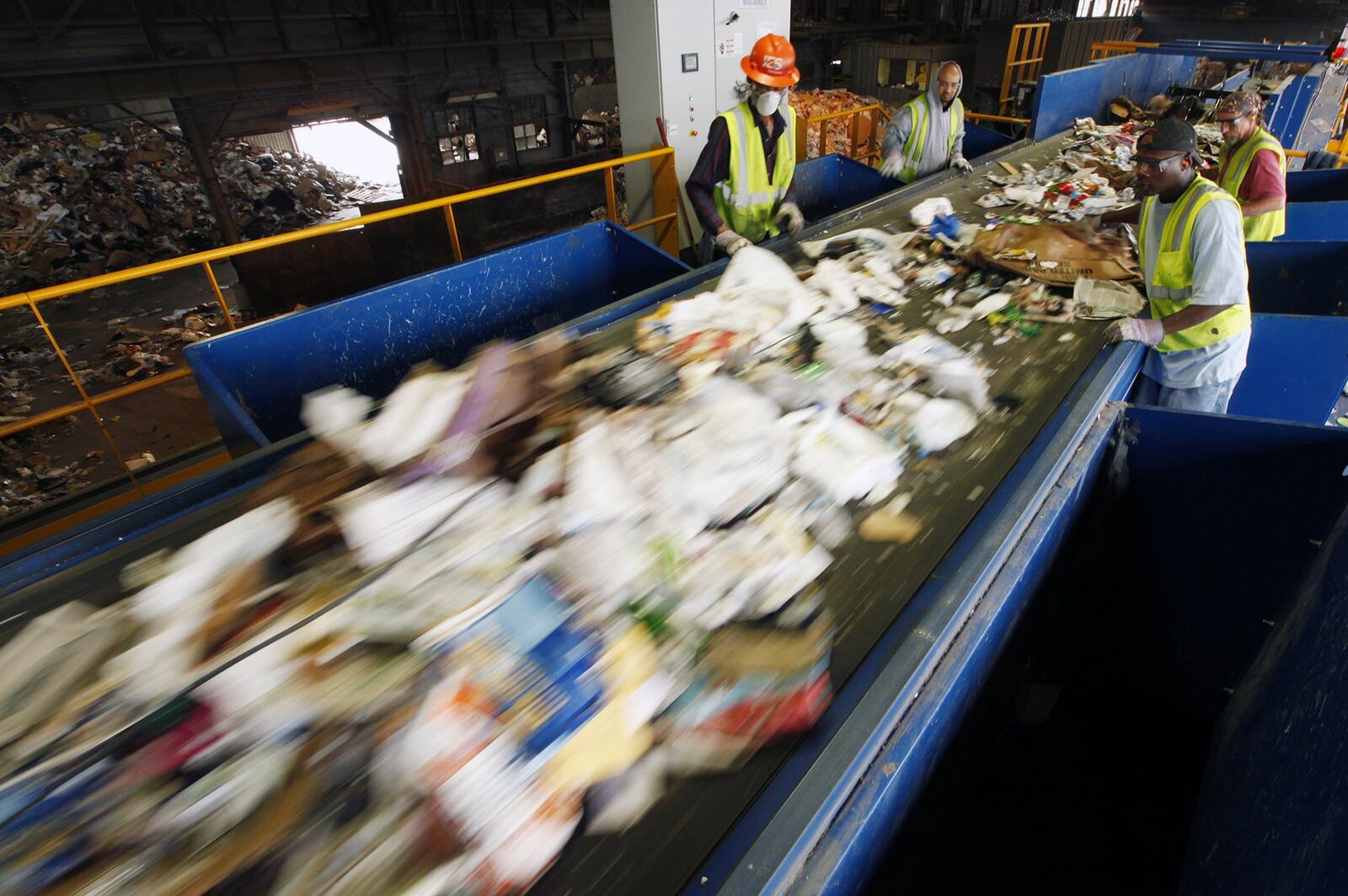 This file shows workers along a new pre-sorting machine at Rumpke Recycling in Dayton. Tightened rules from China are forcing companies to find new markets for recycled products and cut down on the amount of material that should not be put into recycling bins. TY GREENLEES / STAFF