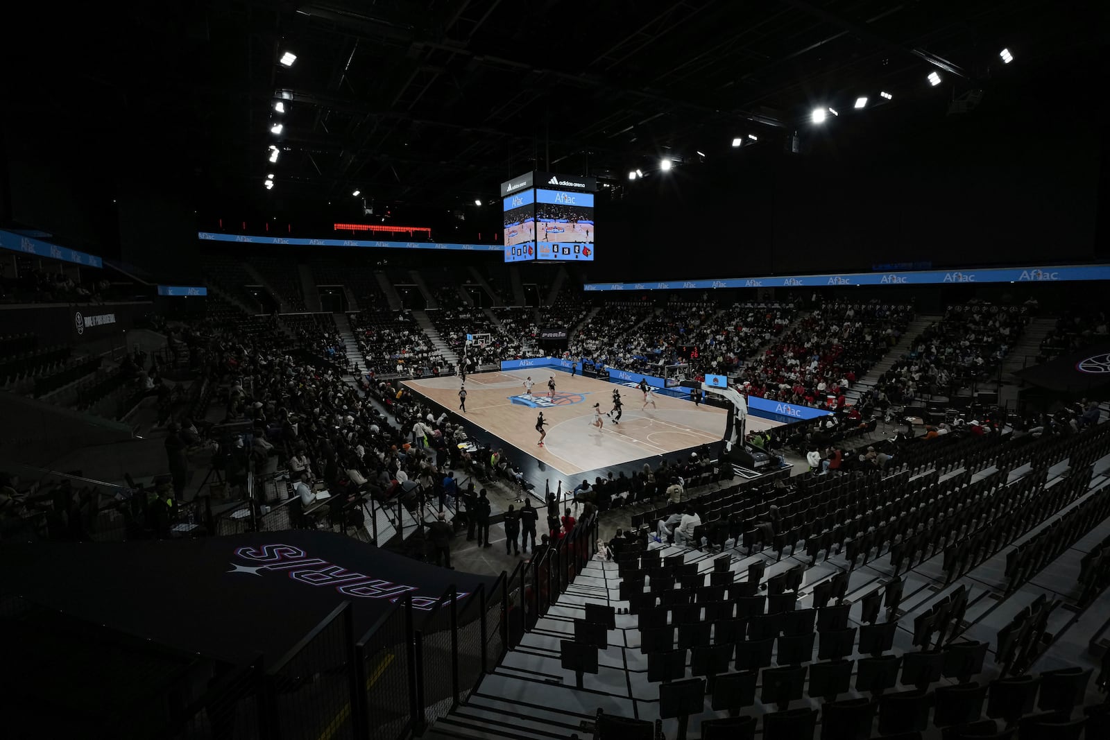 Spectators attend an NCAA college basketball game between UCLA and Louisville, Monday, Nov. 4, 2024, in Paris, France. (AP Photo/Aurelien Morissard)