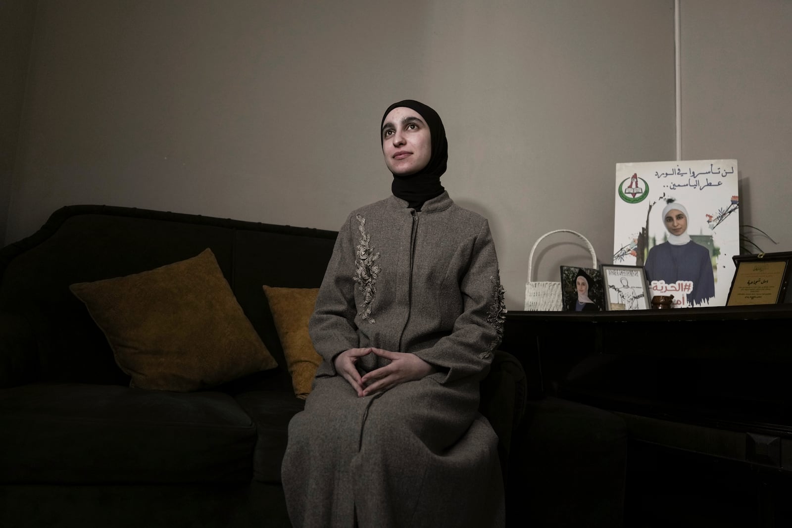 Amal Shujaeiah, a former Palestinian prisoner who was released from an Israeli prison as part of a ceasefire deal between Israel and Hamas, poses for a photo at her home in Dayr Jarir, West Bank, Monday, Jan. 20, 2025. (AP Photo/Mahmoud Illean)