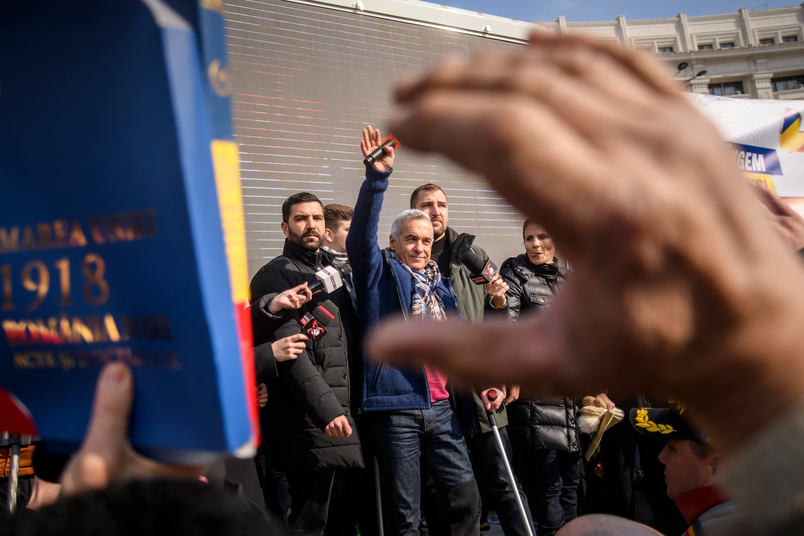 Calin Georgescu, the winner of Romania's first round of presidential election, annulled by the Constitutional Court, waves to supporters gathered for a protest outside the Romanian parliament in Bucharest, Romania, Saturday, Feb. 22, 2025. (AP Photo/Alexandru Dobre)