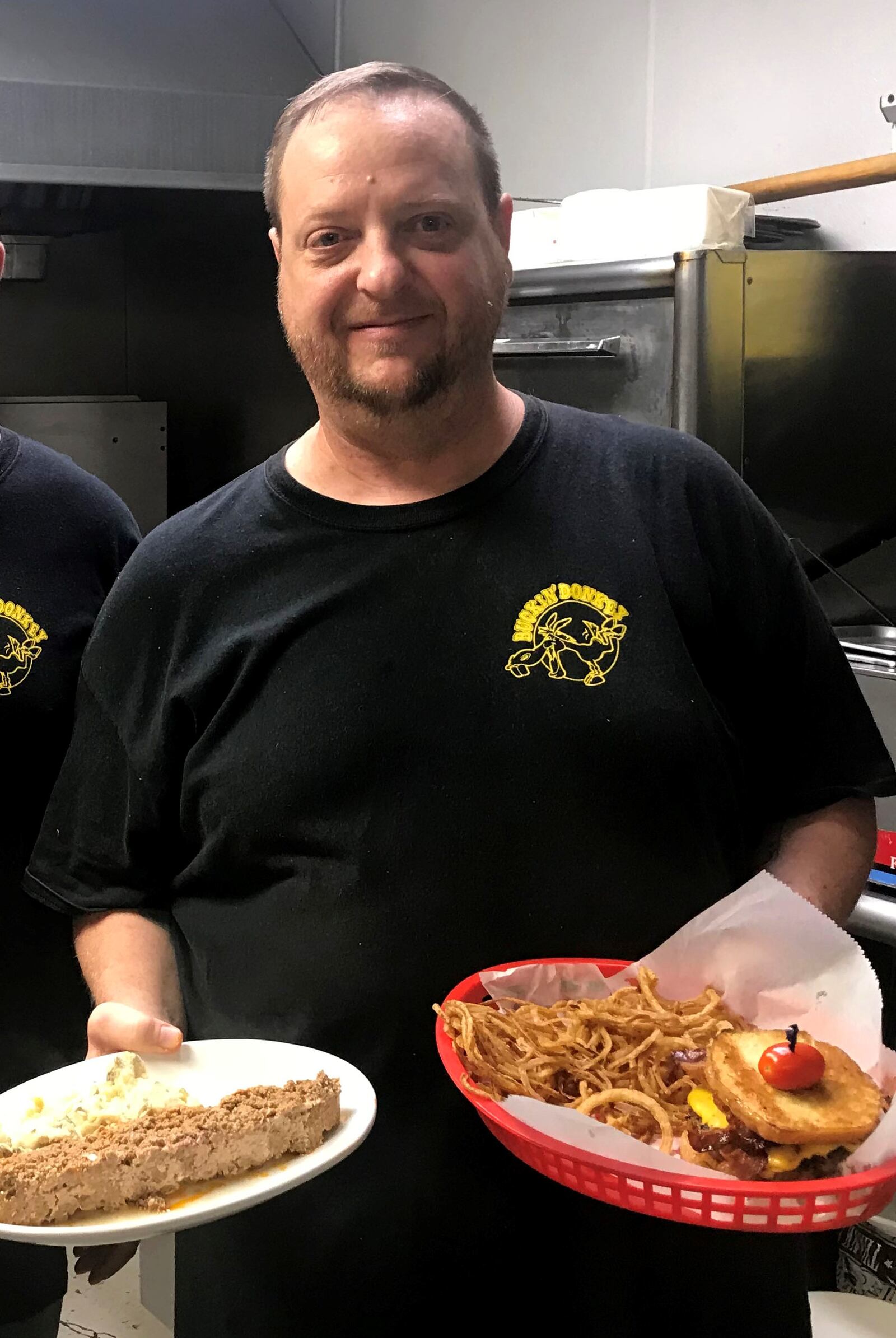 Sean McKown, the co-founder of the Buckin' Donkey in Kettering, shows off some of his restaurant's specialties in August 2018.