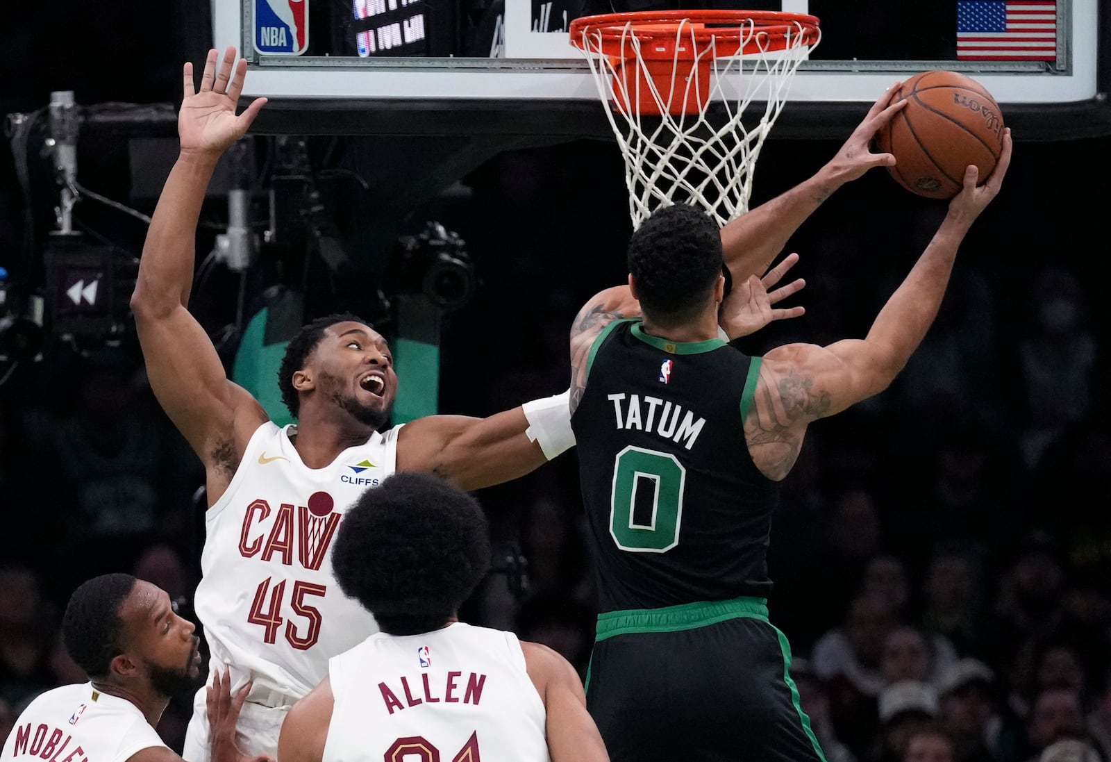 Boston Celtics forward Jayson Tatum (0) drives to the basket against Cleveland Cavaliers guard Donovan Mitchell (45) during the first half of an Emirates NBA Cup basketball game, Tuesday, Nov. 19, 2024, in Boston. (AP Photo/Charles Krupa)