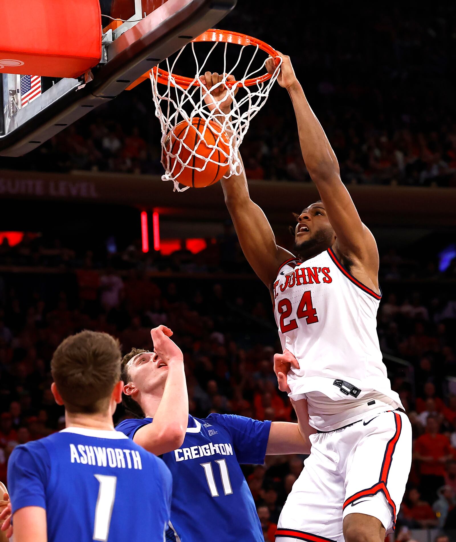 St. John's forward Zuby Ejiofor (24) dunks against Creighton guard Steven Ashworth (1) and center Ryan Kalkbrenner (11) during the second half of an NCAA college basketball game, Sunday, Feb. 16, 2025, in New York. (AP Photo/Noah K. Murray)