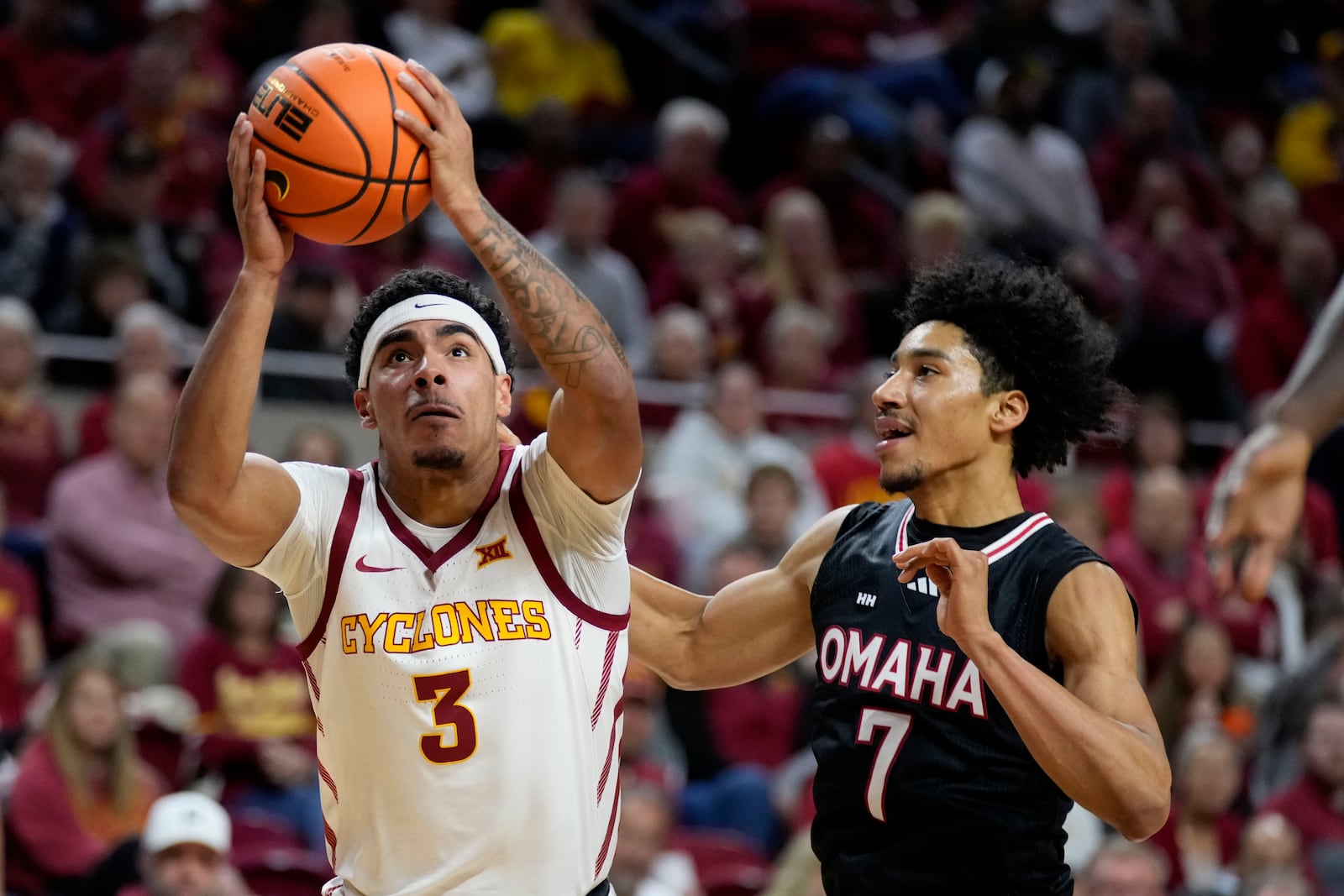 Iowa State guard Tamin Lipsey (3) drives to the basket past Omaha guard Lance Waddles (7) during the second half of an NCAA college basketball game Sunday, Dec. 15, 2024, in Ames, Iowa. (AP Photo/Charlie Neibergall)