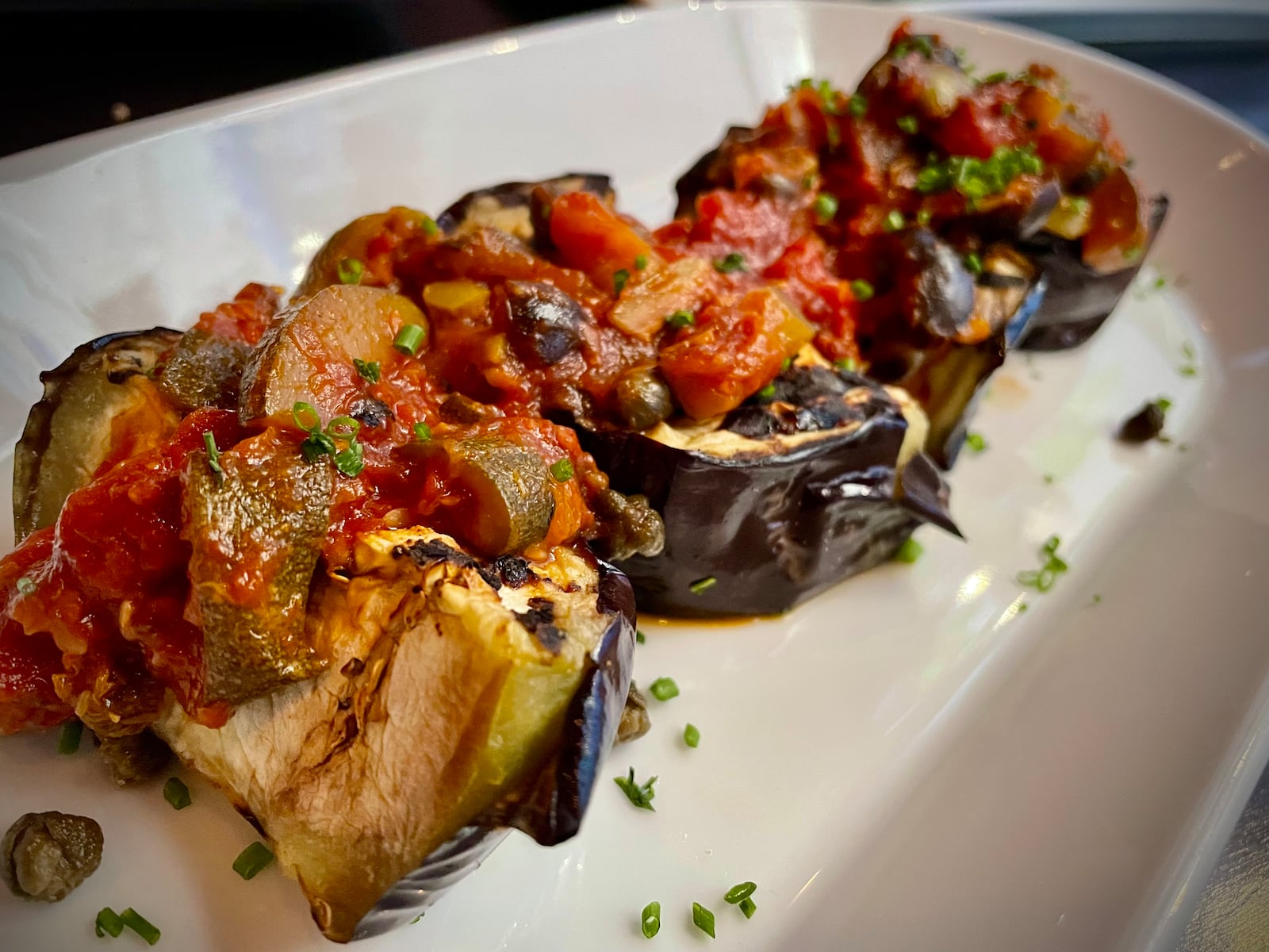 Roost Modern Italian in Dayton’s Oregon District has been rebranded as Culina, an Italian-inspired small plates restaurant and bar. Pictured is the Caponata Di Melanese. NATALIE JONES/STAFF