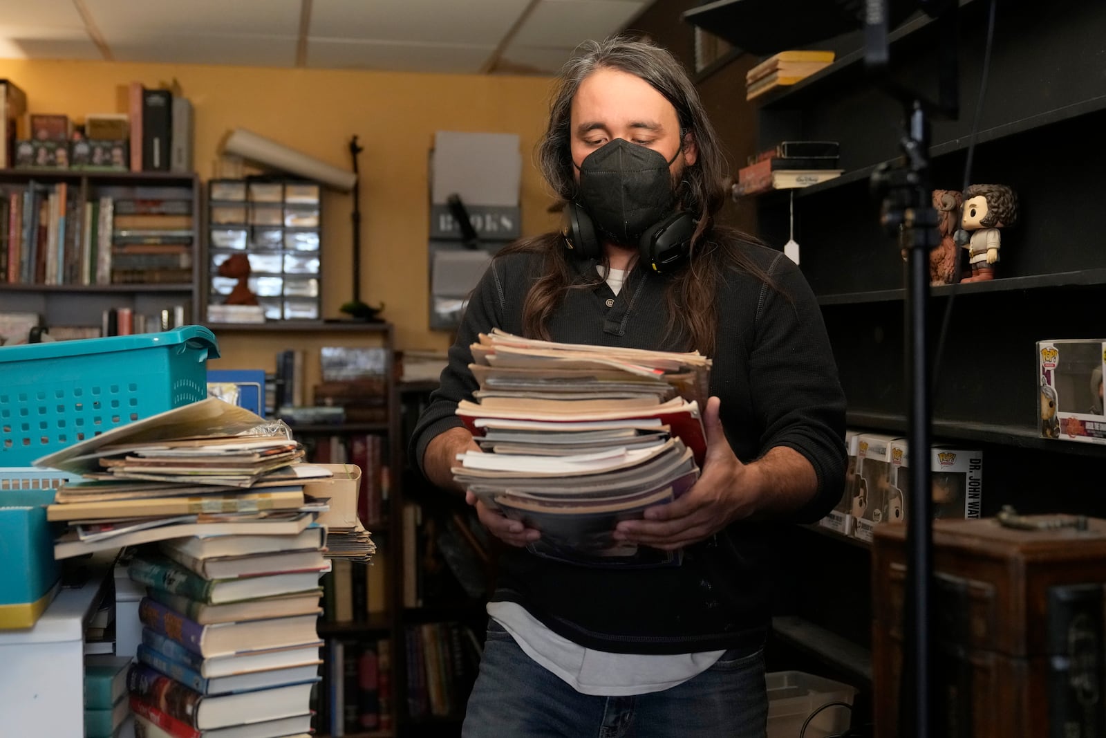 Steve Alejandro works in his office near the room where his wife, Ashley, spends most of her time due to illness in the basement of their home Wednesday, Dec. 18, 2024, in Wentzville, Mo. (AP Photo/Jeff Roberson)