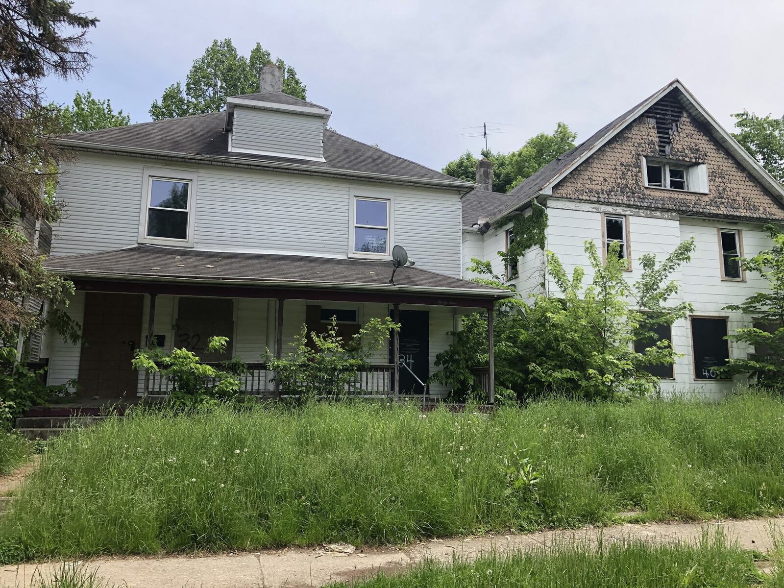 The Fountain Avenue neighborhood in Dayton was hard hit by the foreclosure crisis and has not recovered. Houses all along the street are dilapidated, with broken windows, overgrown yards and boards nailed over doors and windows. PHOTOS by Lynn Hulsey